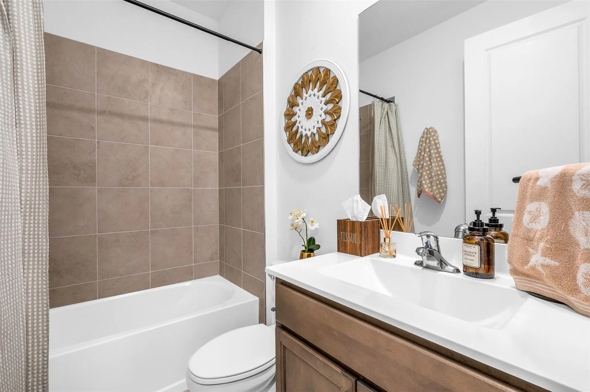 White single-basin vanity with an integrated countertop, chrome-finish faucet, and coordinating wood-finish cabinetry