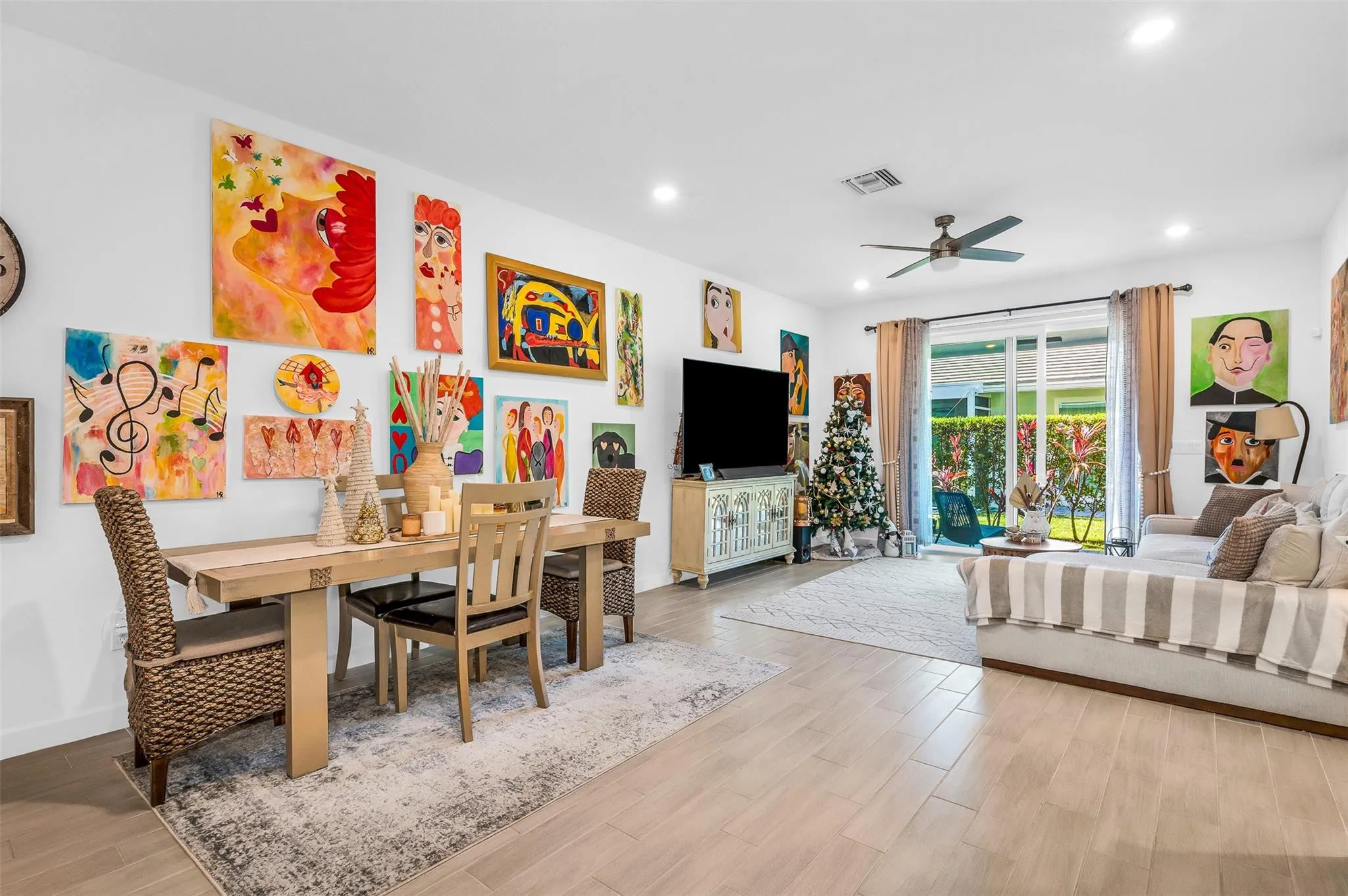 Open-concept living space with light tile flooring, recessed lighting, and a ceiling fan