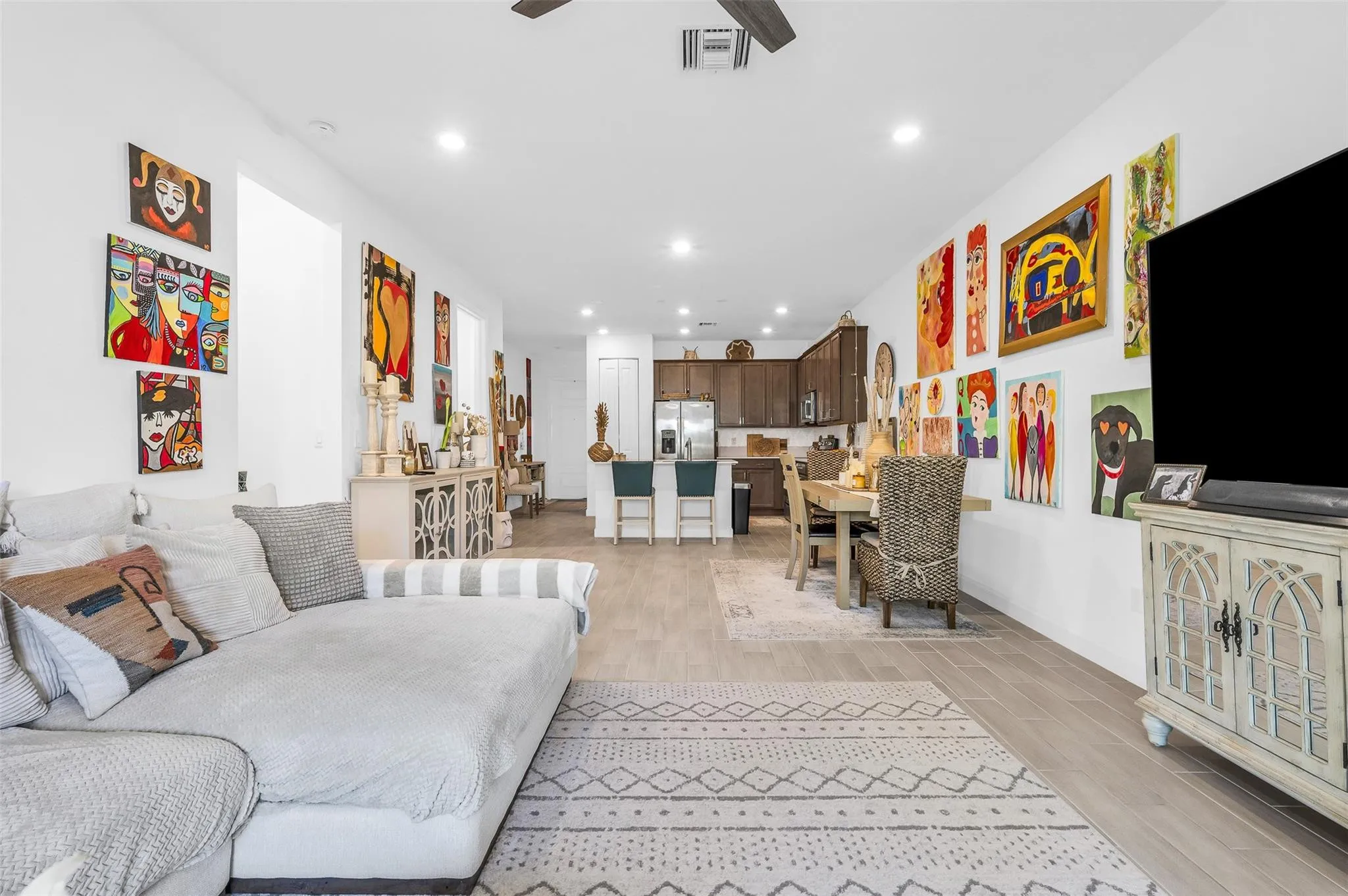 Open-concept living area with recessed lighting, tile flooring, and a ceiling fan