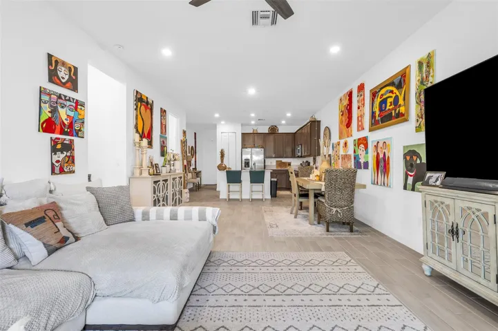 Open-concept living area with recessed lighting, tile flooring, and a ceiling fan