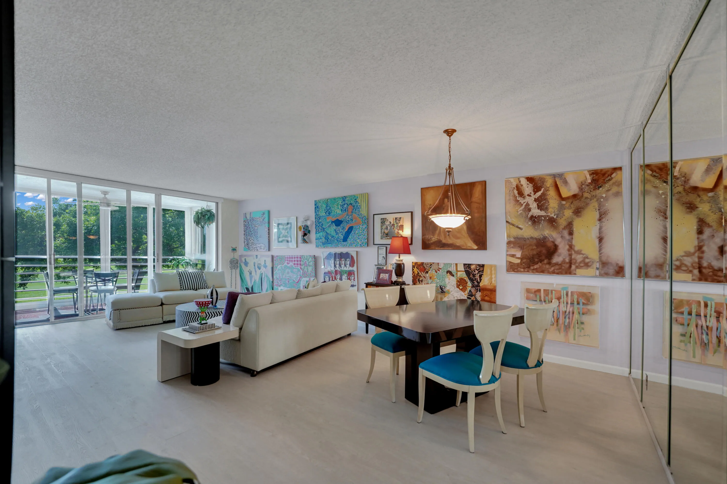 Living room-dining room w sliders to glass impact all year balcony