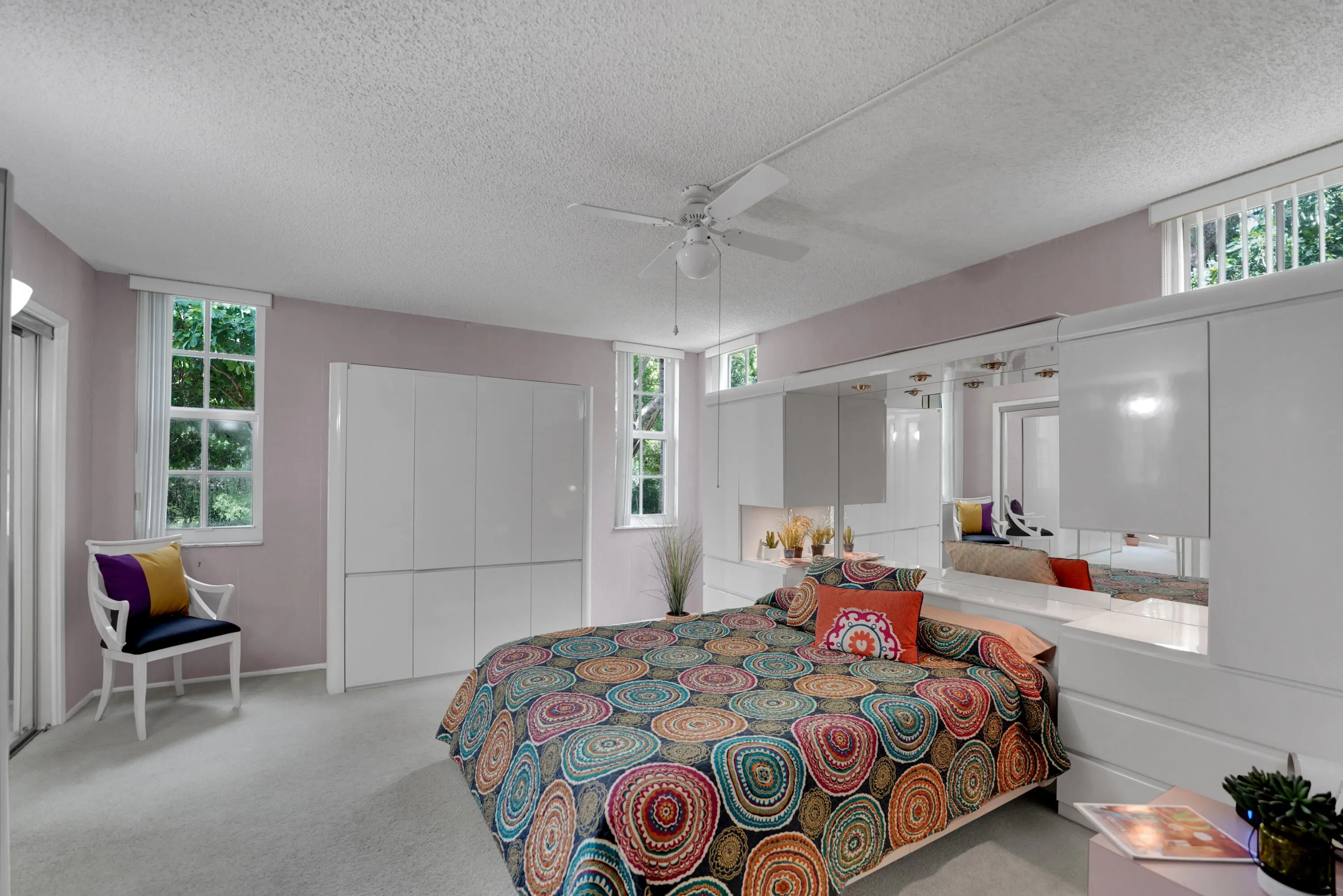 Large primary bedroom with many windows as its an end unit.