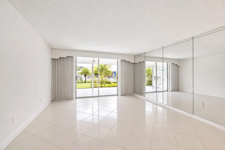 Bright, open living space flooded with natural light through expansive glass doors and windows