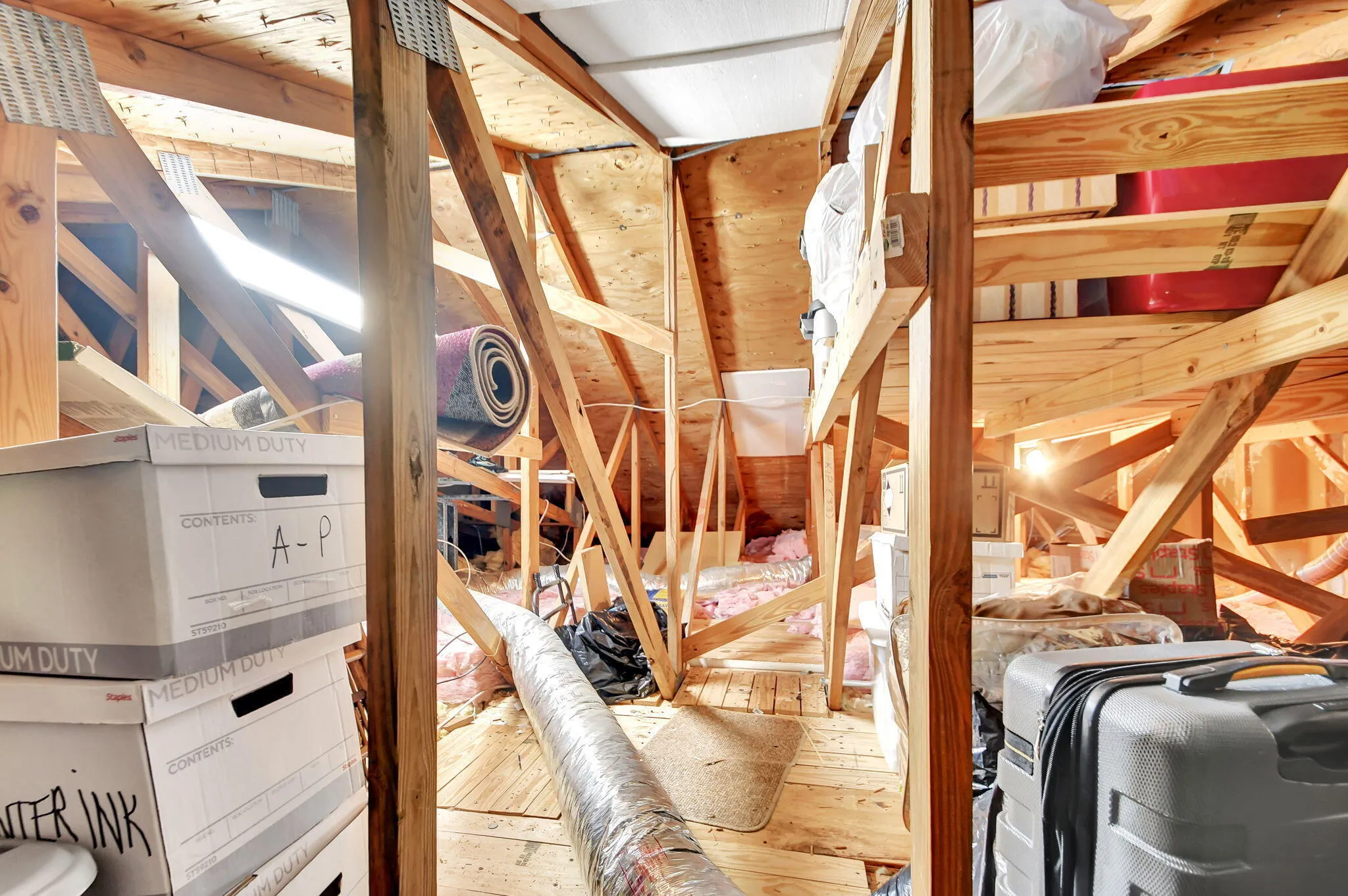 Pull down attic stairs leads to extra storage.