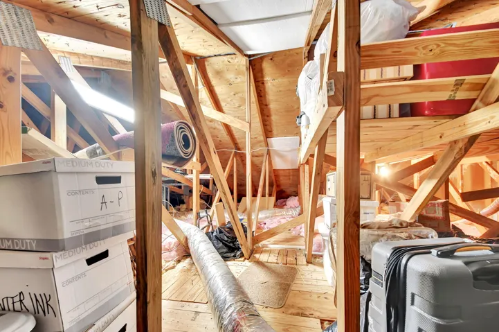 Pull down attic stairs leads to extra storage.