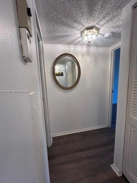 Hall way inside unit to kitchen from room