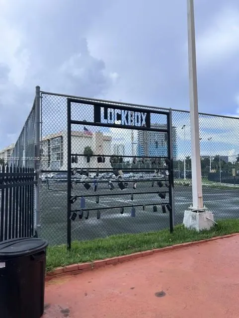 Lock box on Tenis court fence across from admin office