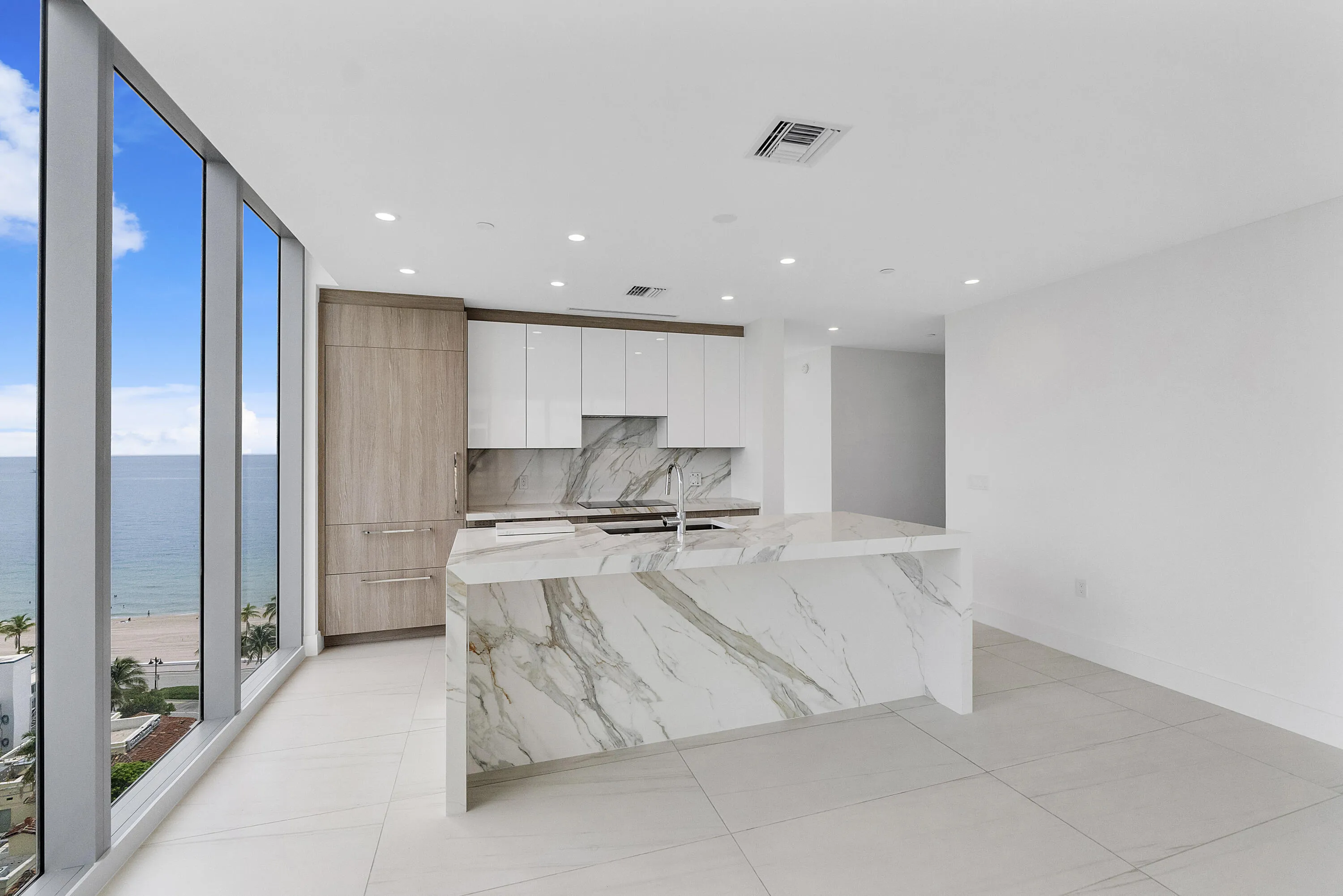 This 10th floor custom designer unit has never been lived in,Updated European porcelain kitchen island and backsplash, Brianna soft close cabinets, Italian porcelain 48 inch flooring