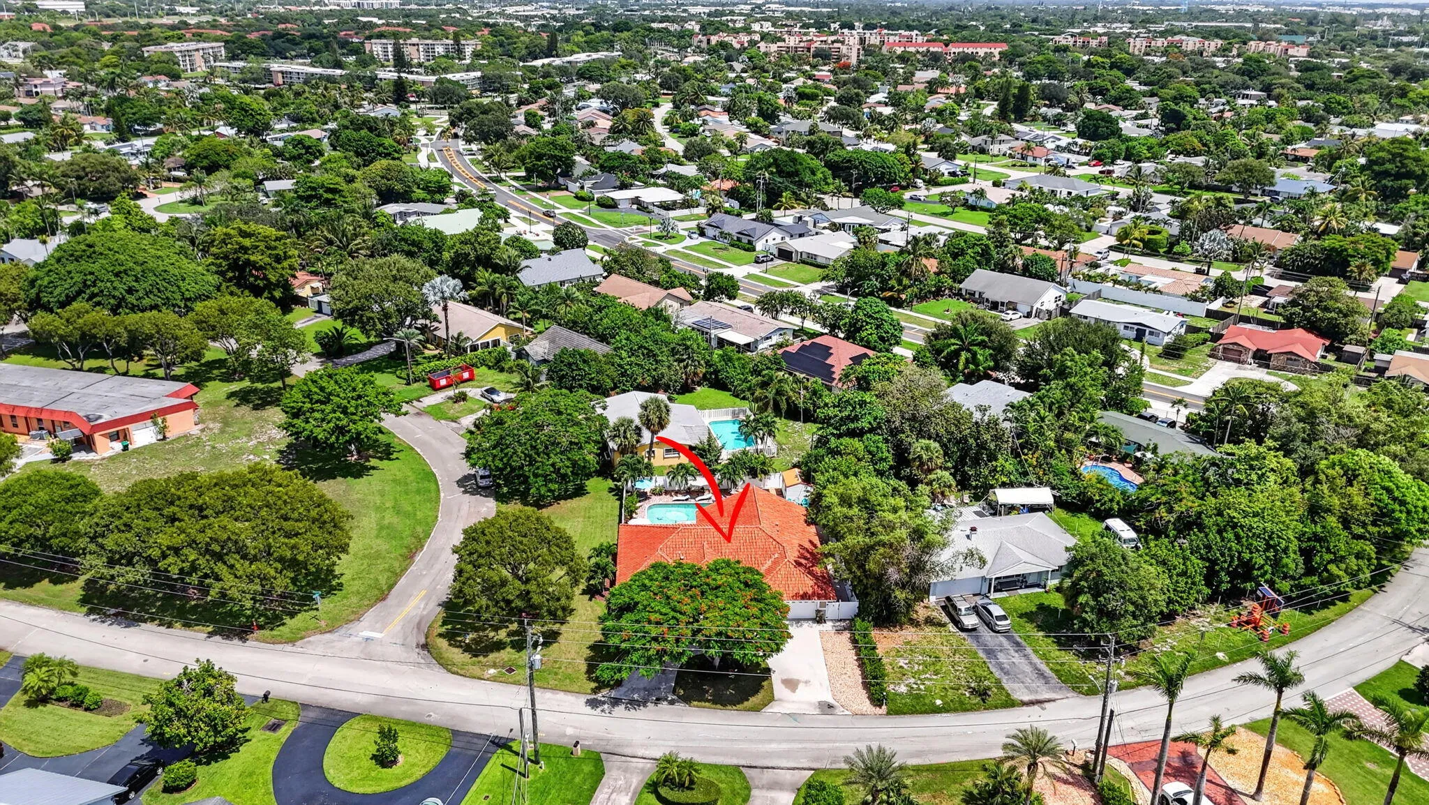 Property featuring a red tile roof, private swimming pool, and mature landscaping