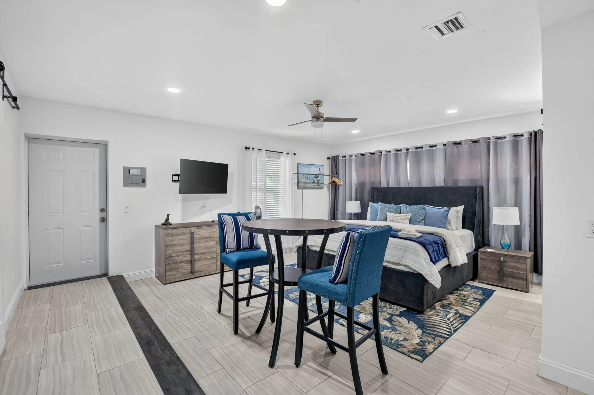 Recessed lighting, ceiling fan, tile flooring, and a built-in wall unit