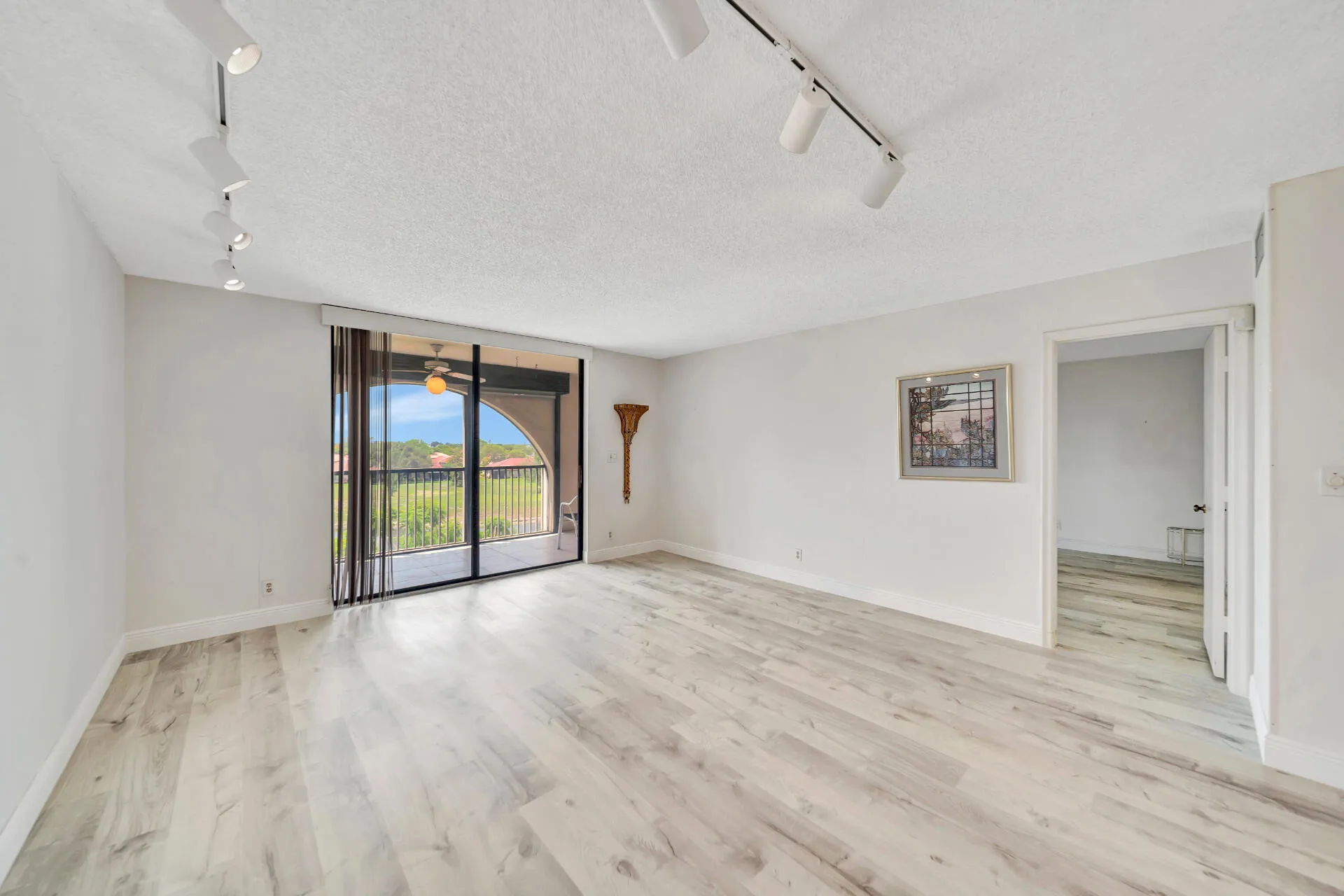 Spacious Living Room with Screened Balcony Entry