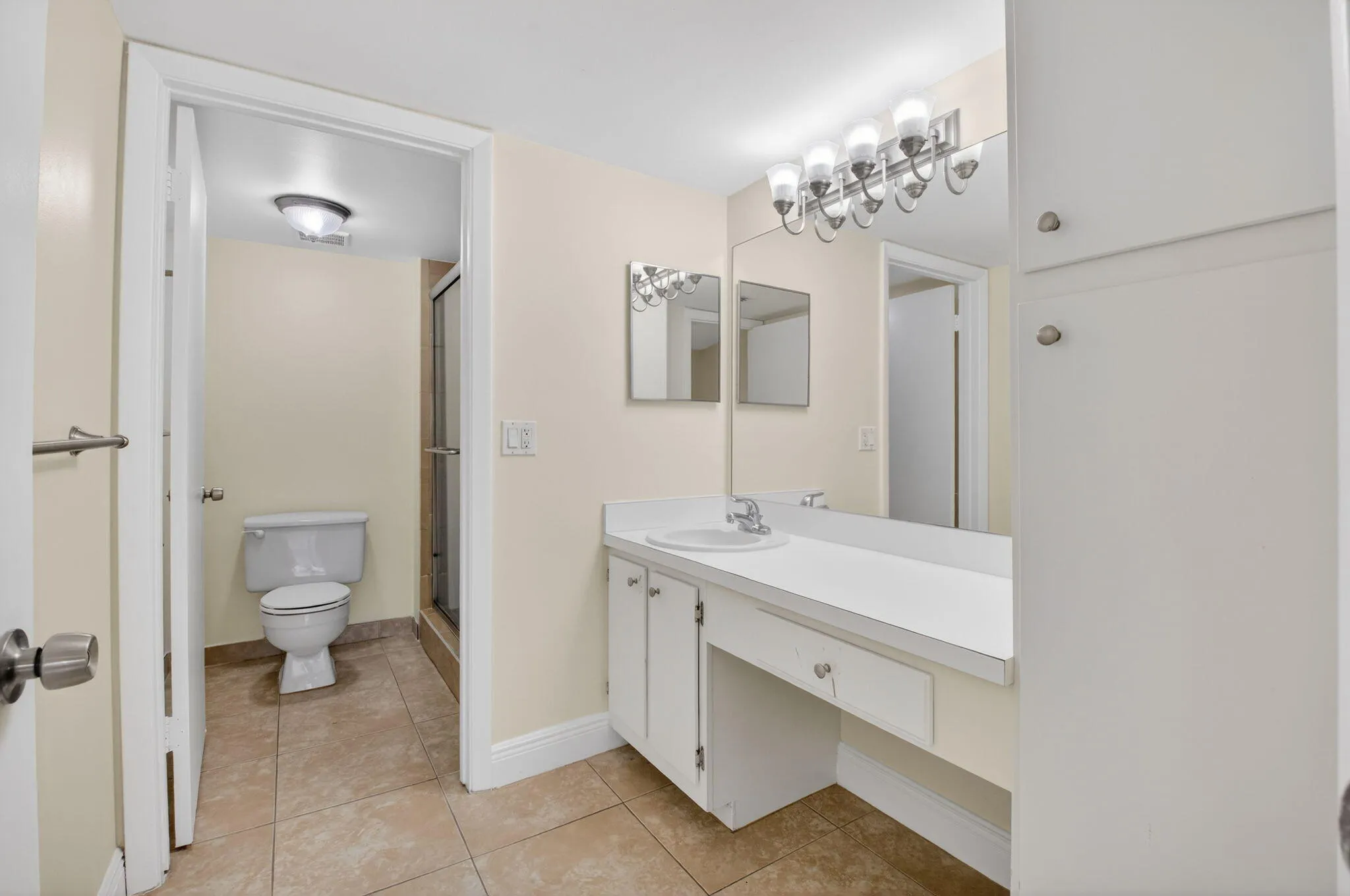 Vanity with integrated sink, extensive counter space, and built-in storage cabinetry