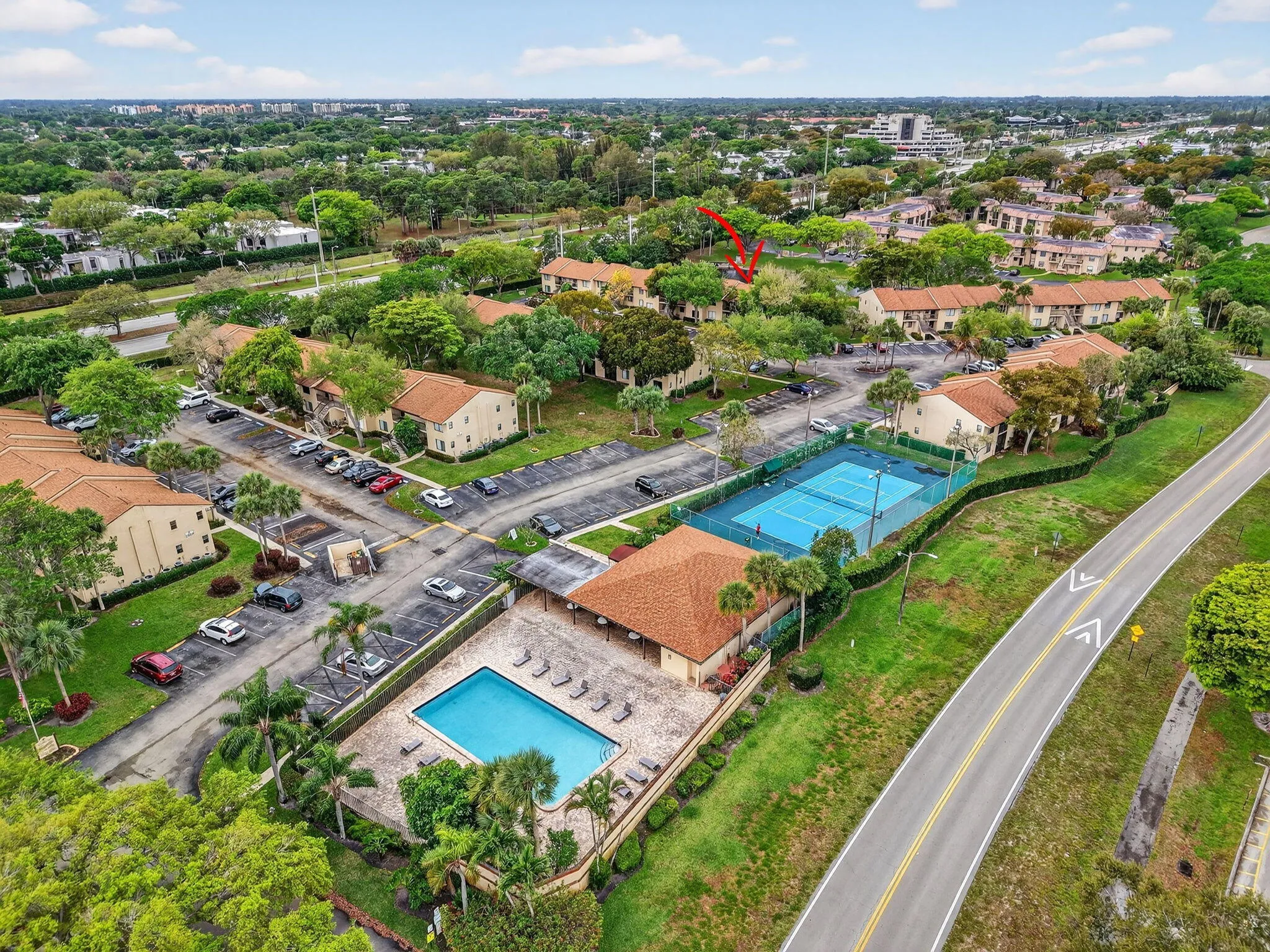 Community featuring an outdoor swimming pool, tennis courts, and multi-unit residences