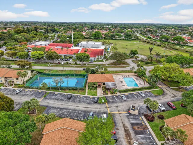 Community amenities featuring a tennis court, swimming pool, and dedicated parking areas