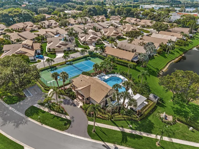 Resort-style residence with a private swimming pool, two tennis courts, and landscaping