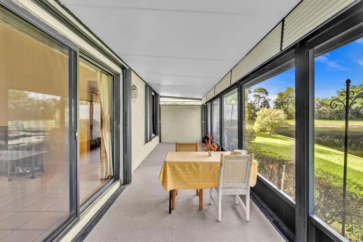 Screened patio with large windows overlooking a landscaped area