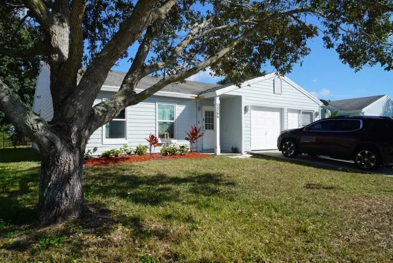 Single-story residence featuring light-colored siding, an attached two-car garage, and a covered​​‌​​​​‌​​‌‌​‌‌​​​‌‌​‌​‌​‌​​​‌​​ entry