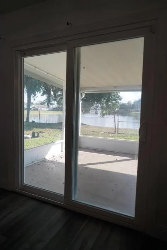 Sliding glass doors opening to an outdoor patio with a water feature