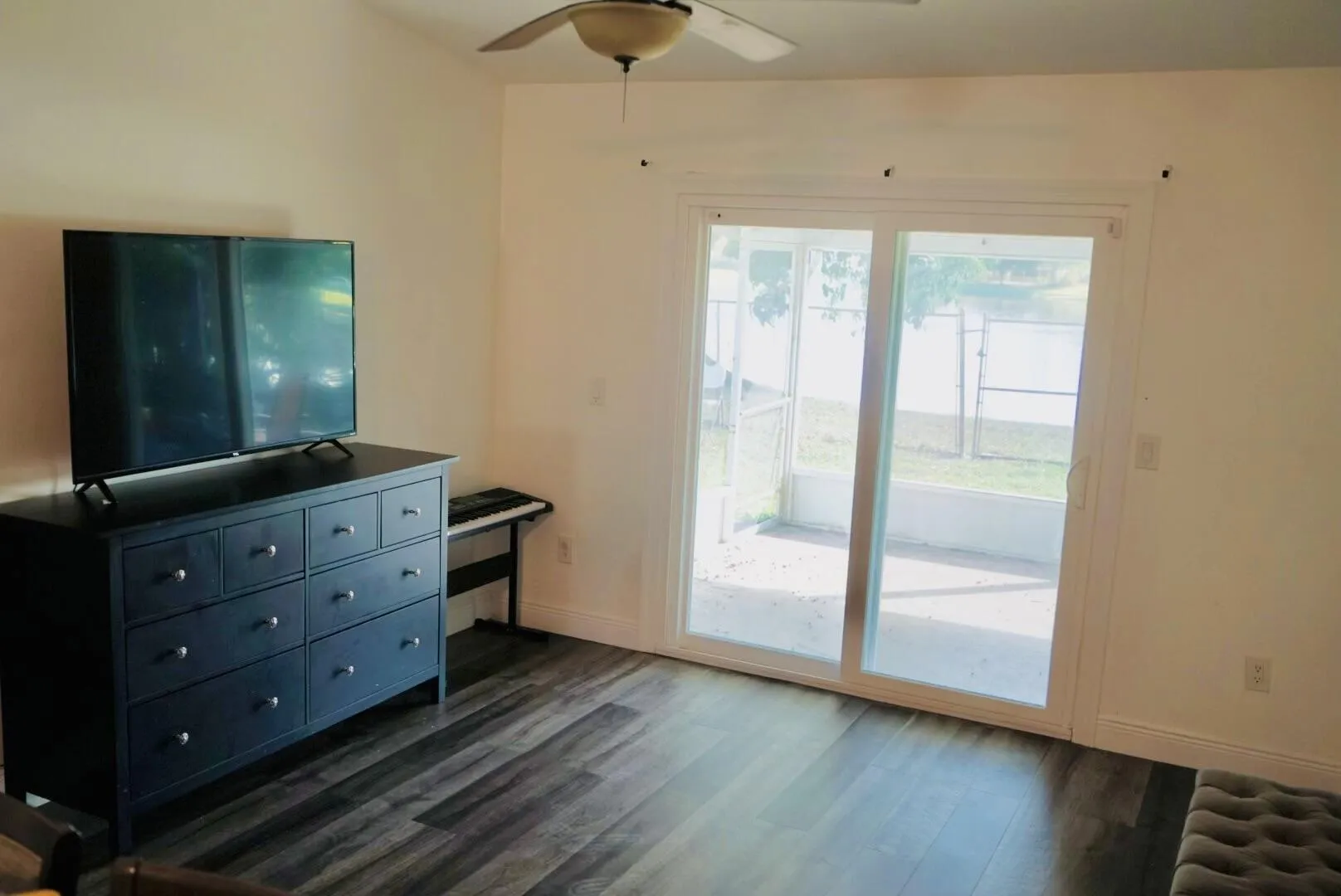 sliding door leads to patio, vaulted ceiling, wood finish flooring, waterfront view from kitchen.