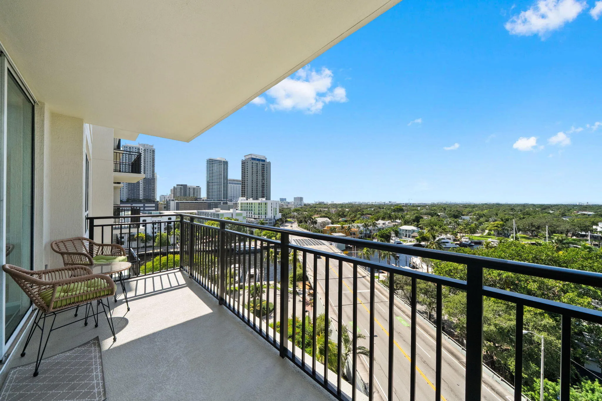 Furnished section of the wraparound terrace offering a comfortable outdoor setting with New River, Sailboat Bend & downtown skyline views.