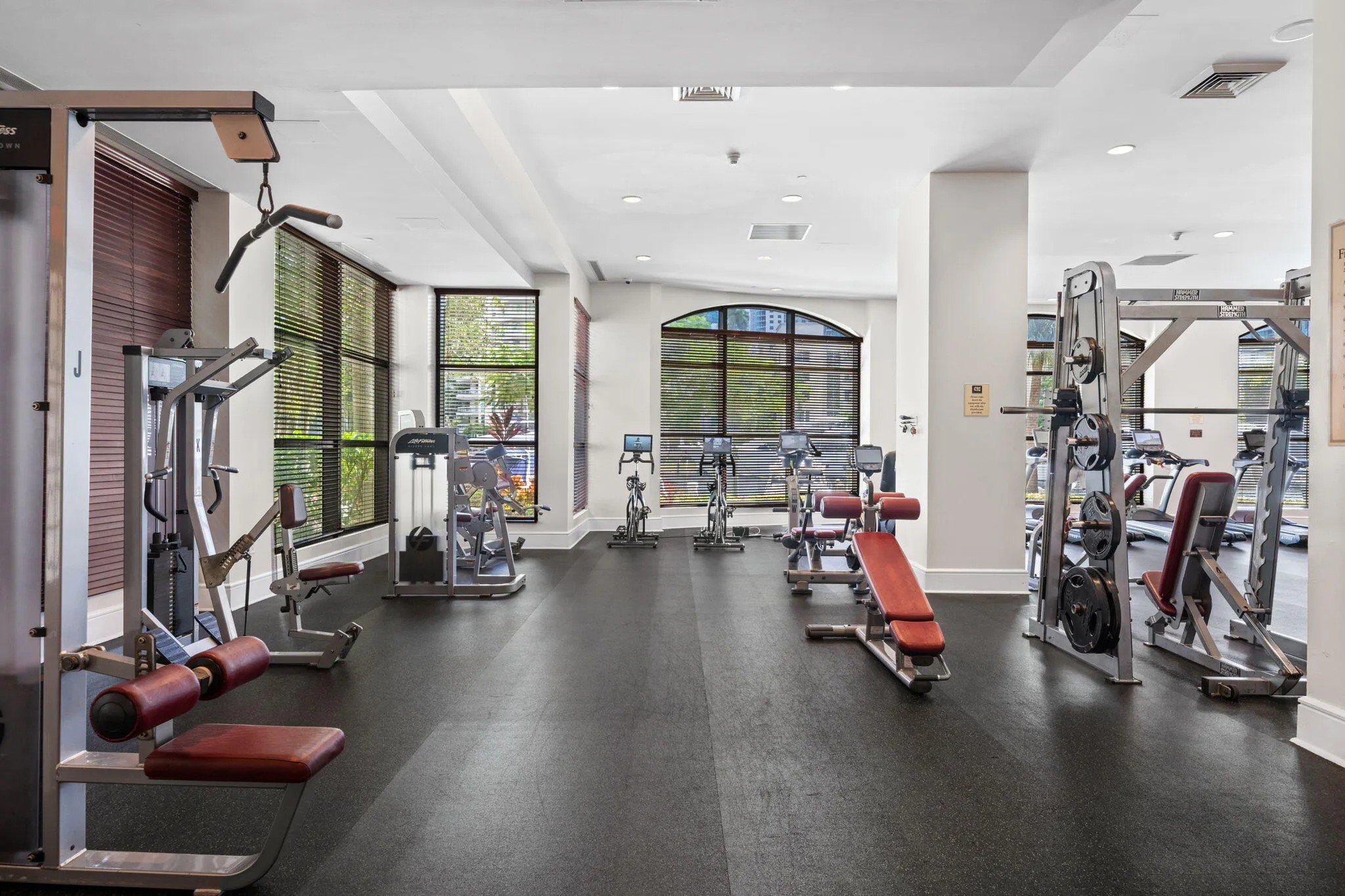 Spacious fitness center with a broad selection of strength-training equipment, cardio machines & natural light with views of the New River.