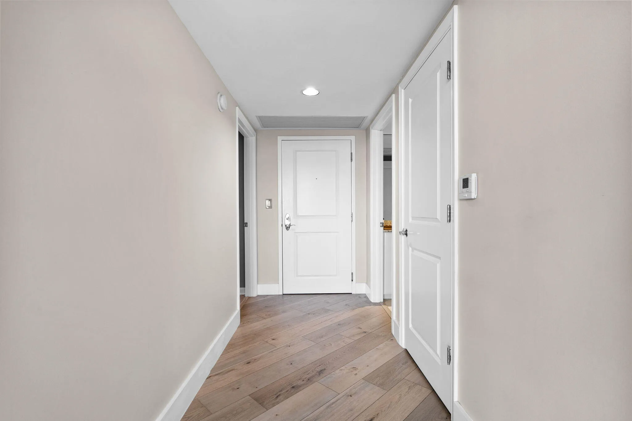 Entry foyer & hallway connecting the residence’s split-bedroom layout and main living areas.