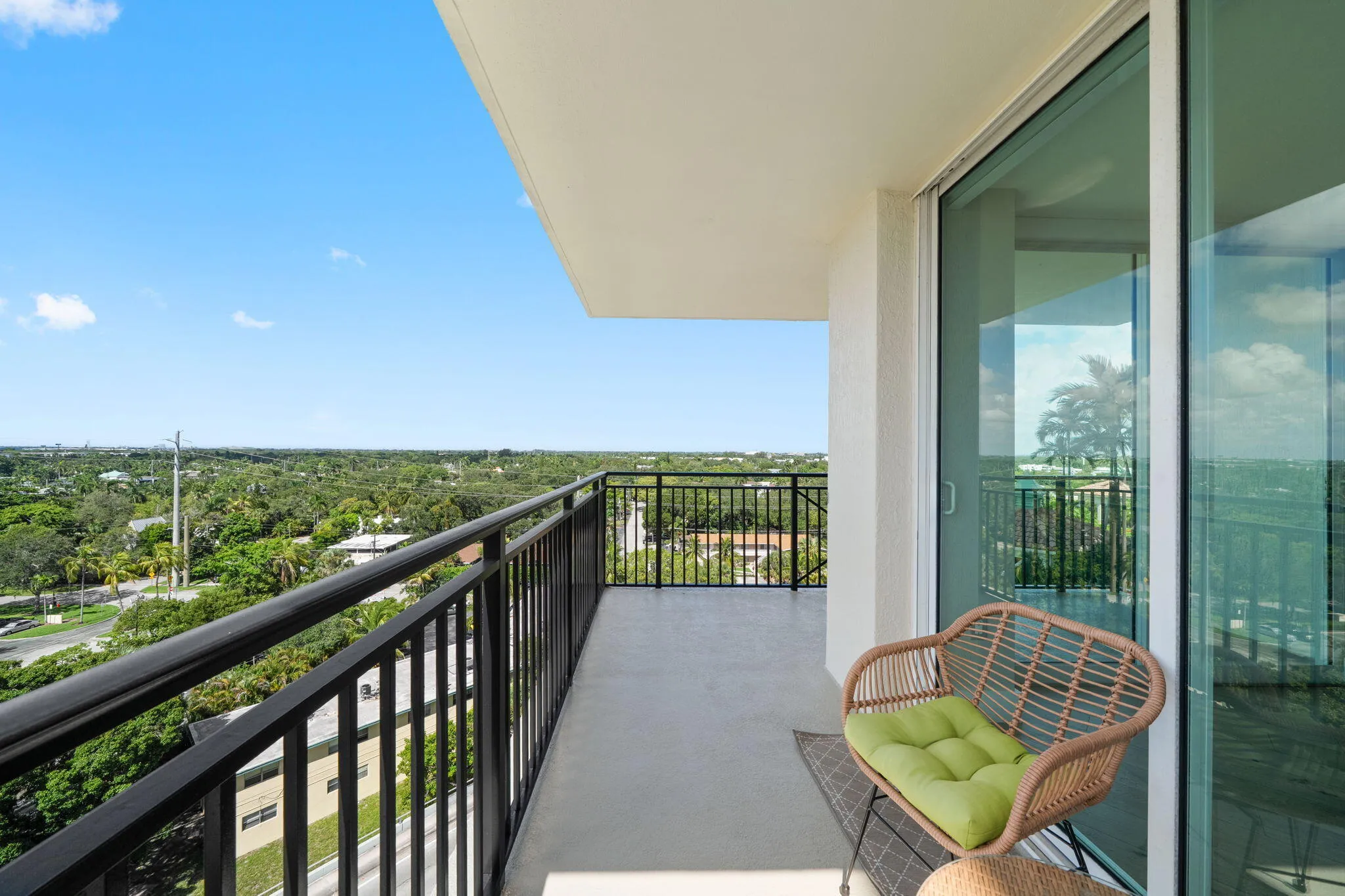 Covered terrace with seating area, creating a comfortable outdoor extension of the residence with broad neighborhood views.