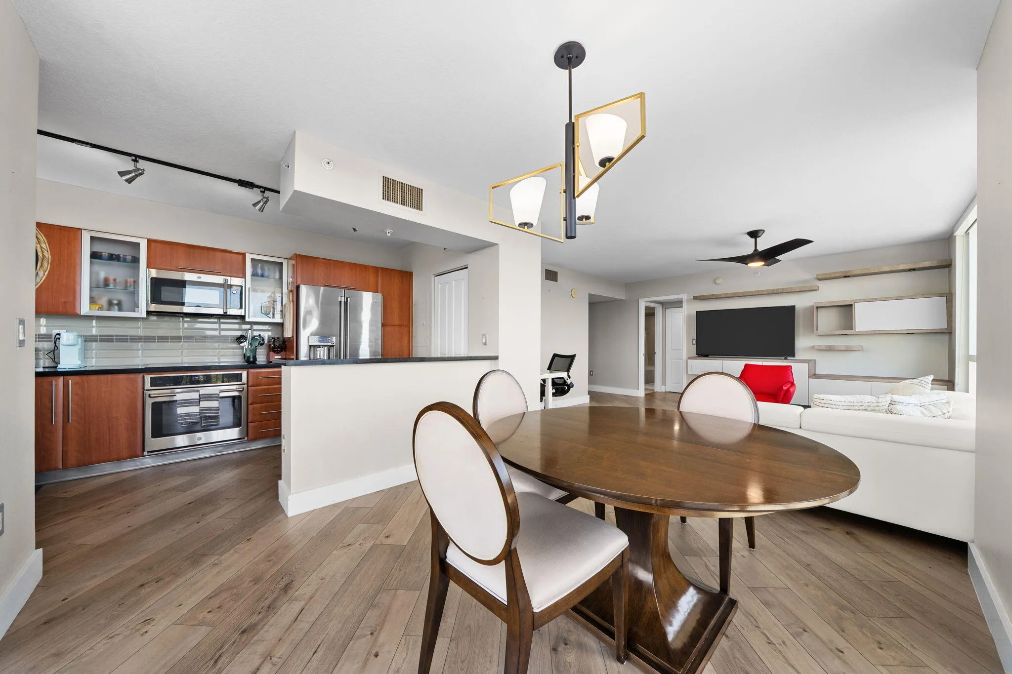Open dining area connecting naturally to the kitchen & living room, with wood-look flooring and a bright, open layout.
