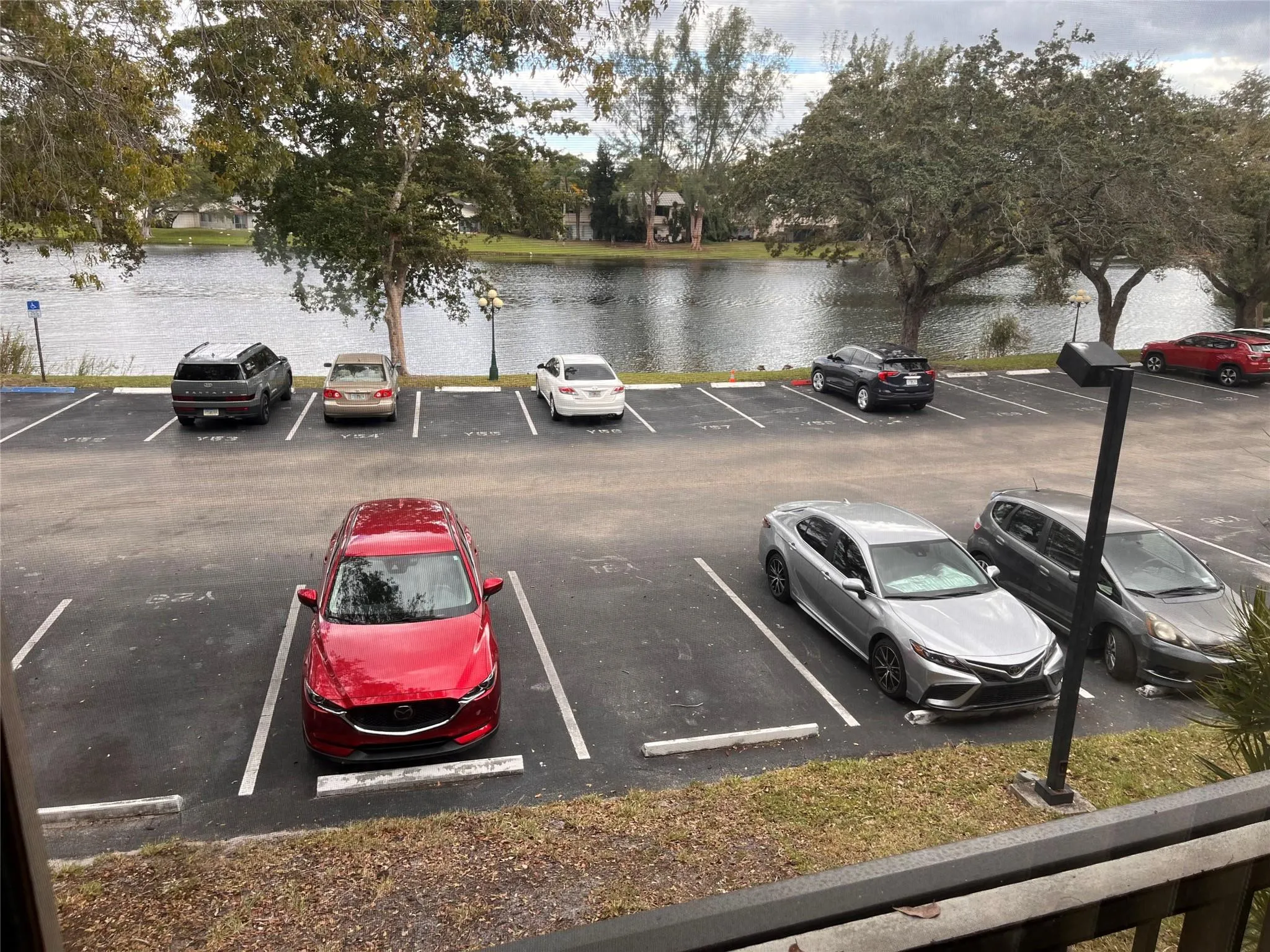 View from the patio of the Lake And parking is where the red vehicle is parked