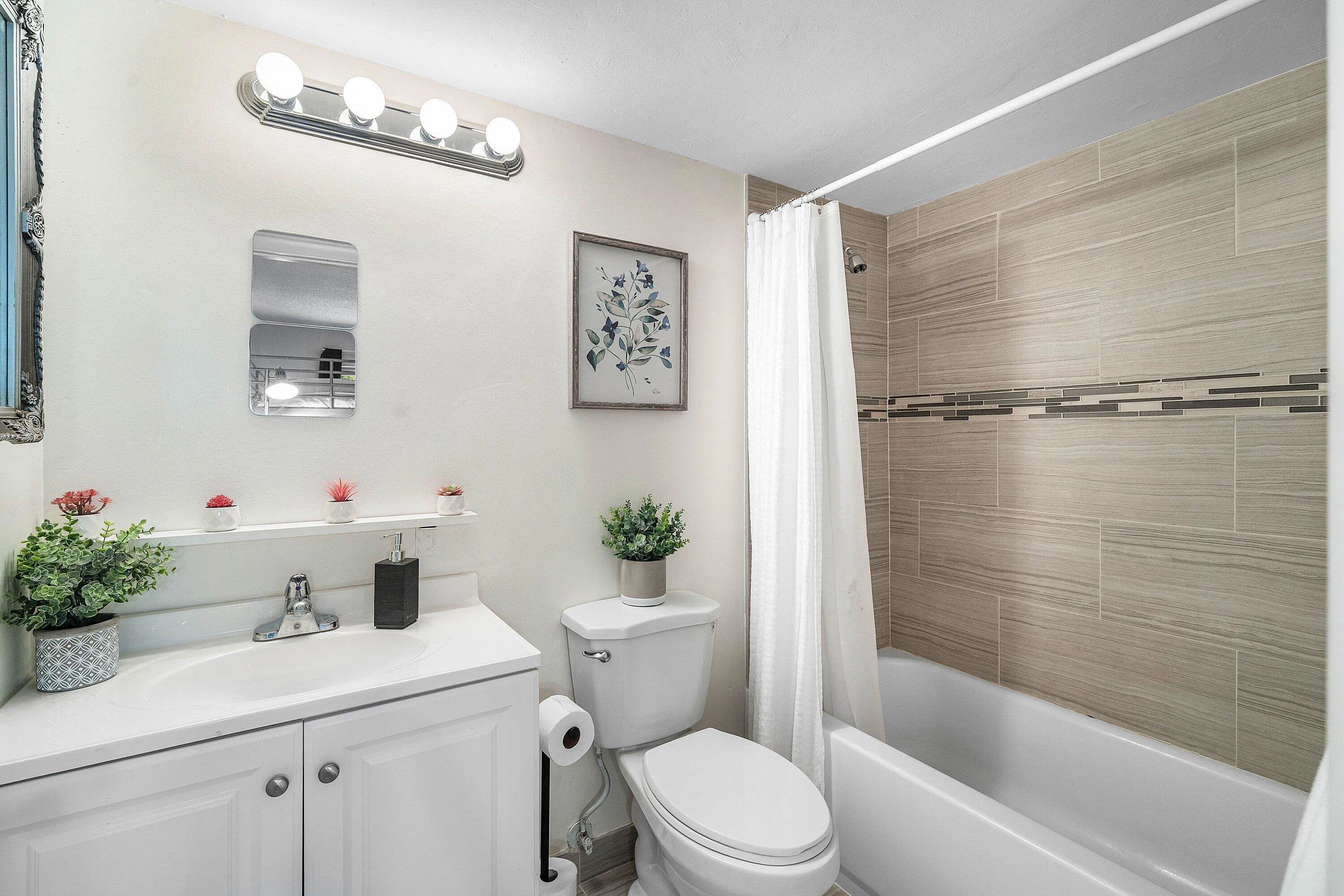White vanity with integrated sink, chrome faucet, and built-in storage