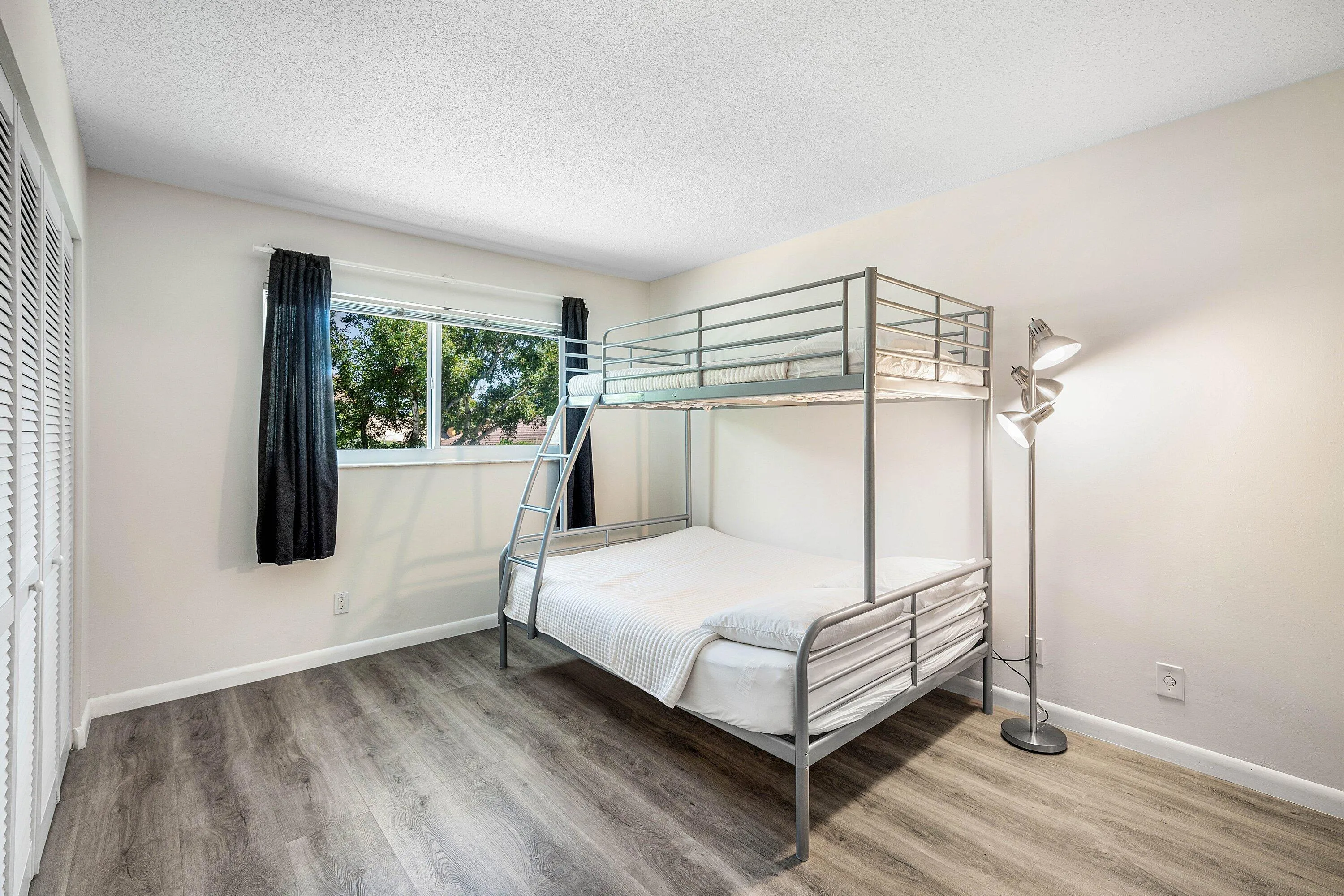 Expansive room featuring wood-finish flooring and a window