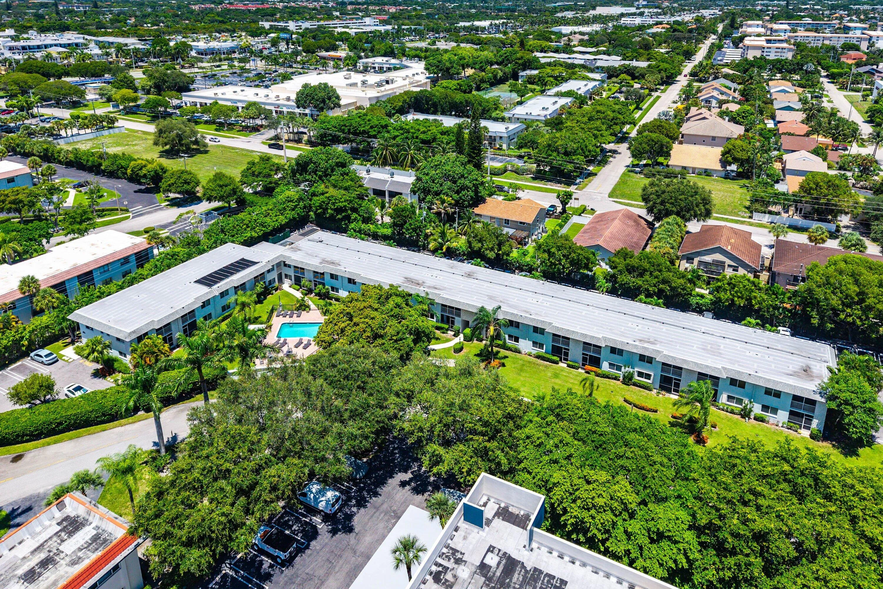 Community building with solar panels, central courtyard, and swimming pool