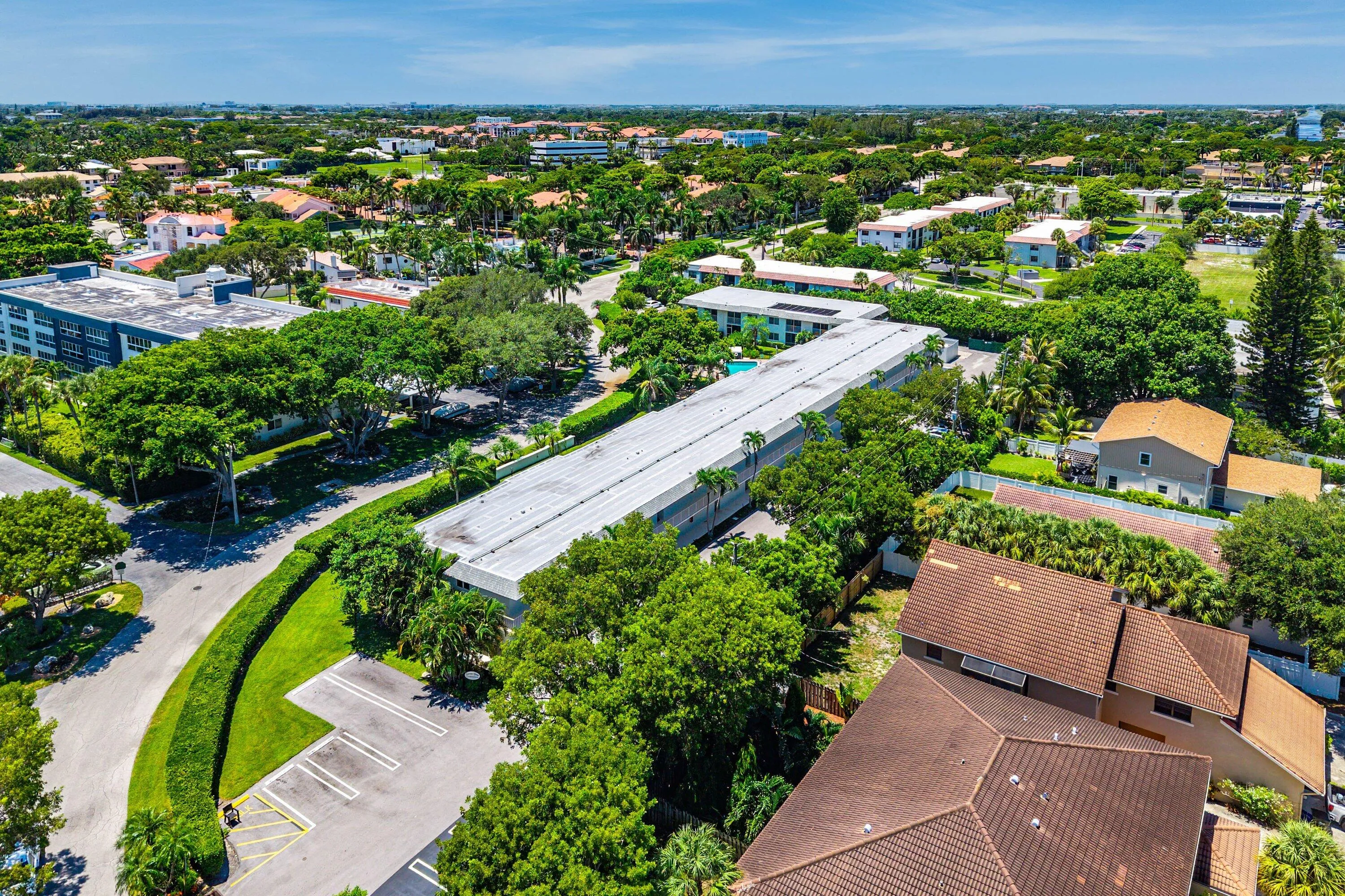 Residential neighborhood with lush tree canopy and multiple dwelling types