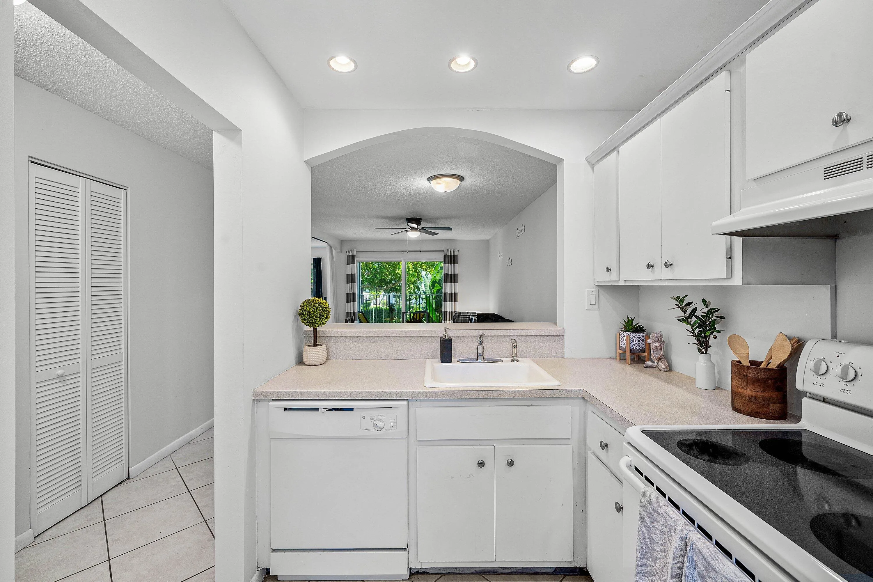 Kitchen featuring white cabinetry, a built-in dishwasher, an electric range, and recessed lighting
