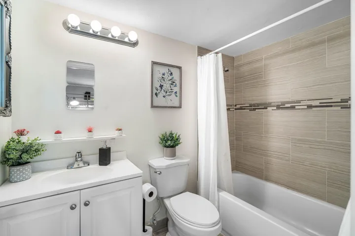 White vanity with integrated sink, chrome faucet, and built-in storage