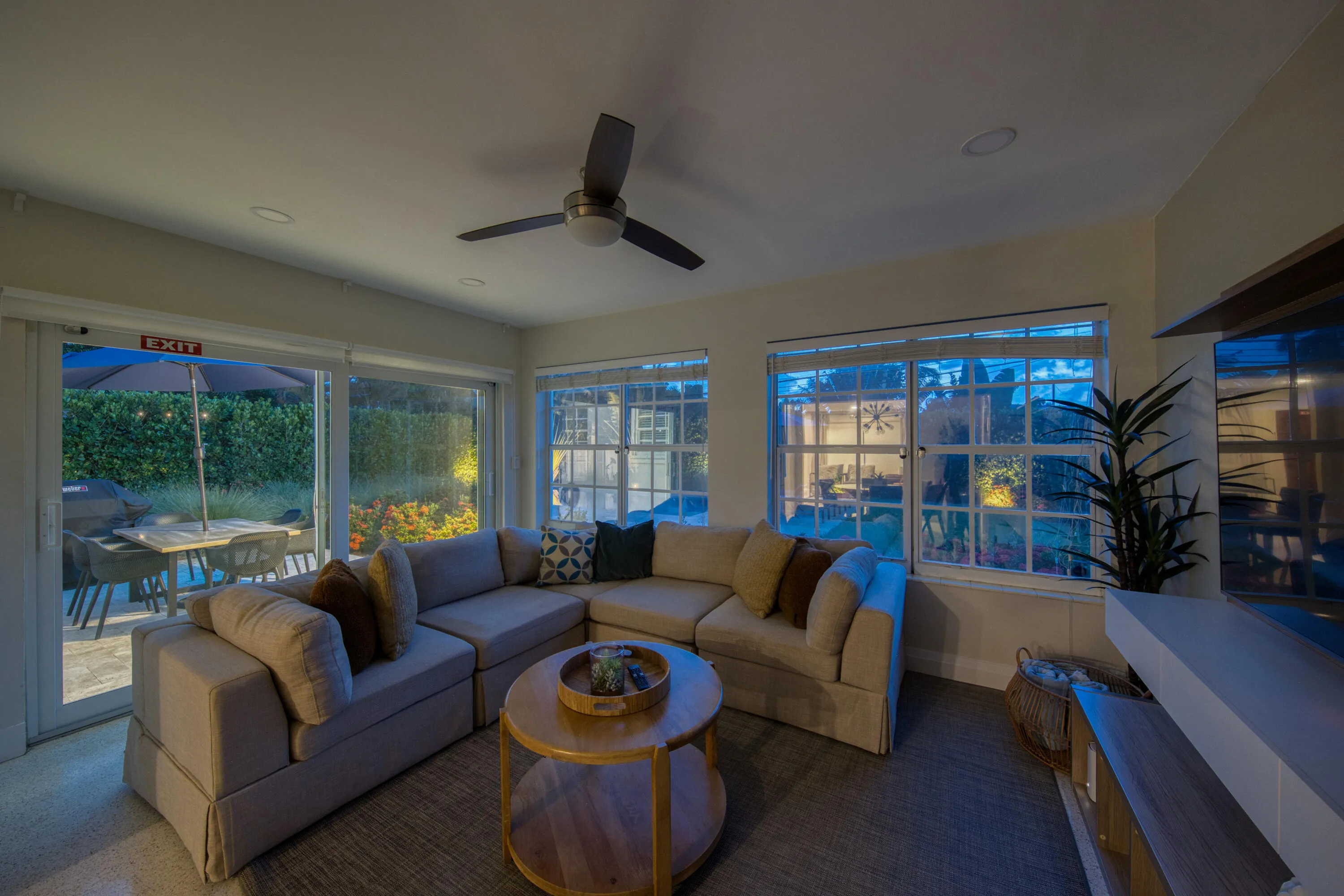 Recessed lighting, ceiling fan, multiple windows, and sliding glass doors