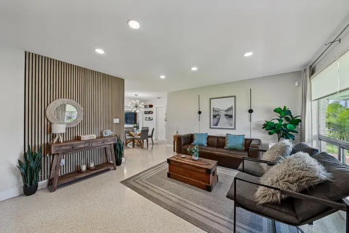 Recessed lighting, wood-slat accent wall, and large windows