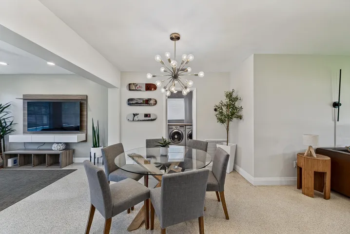 Recessed lighting, contemporary chandelier, stone-finish flooring, built-in shelving