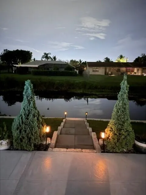 Enjoy the seamless connection to the outdoors while relaxing on your outside couch overlooking the calm water view.
