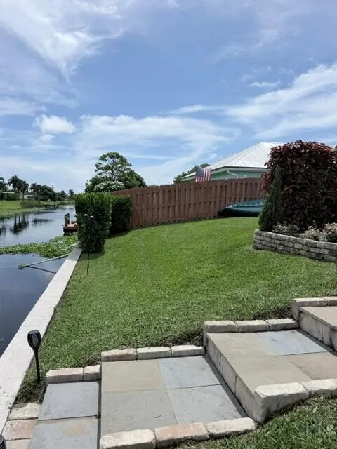 This expansive waterfront property offers a generous backyard with lush green space and plenty of room to relax, play games and enjoy the outdoors.