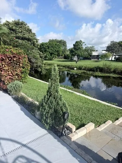 Direct canal frontage, mature landscaping, and thoughtfully designed outdoor areas create a private and peaceful backyard.