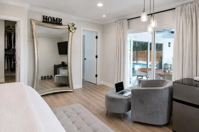 Generous proportions provide plenty of room for comfortable furnishings while maintaining an open feel with a view of the pool.