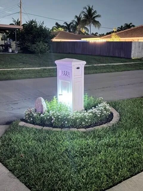 Beautiful illuminated, landscaped modern mailbox.