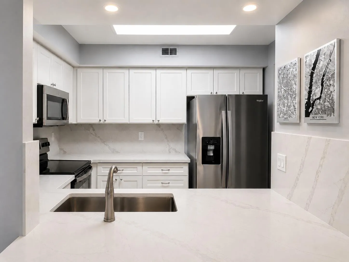 Open-concept kitchen with quartz countertops and breakfast bar seating