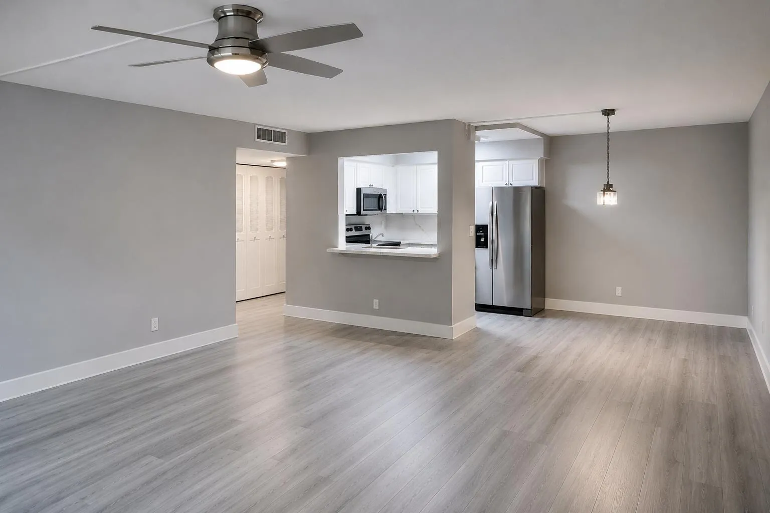 "Empty version" Large, open living and dining area with plenty of room to relax and entertain