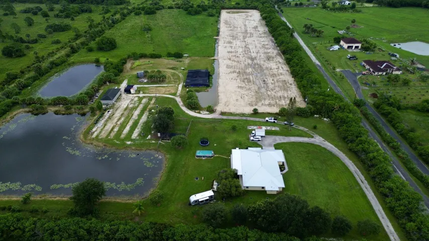 Expansive property featuring multiple ponds, a substantial cleared land area, and a private driveway