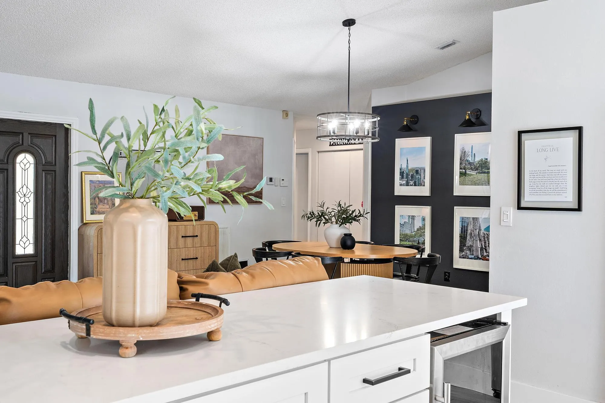 White kitchen island with shaker-style cabinetry and a built-in appliance