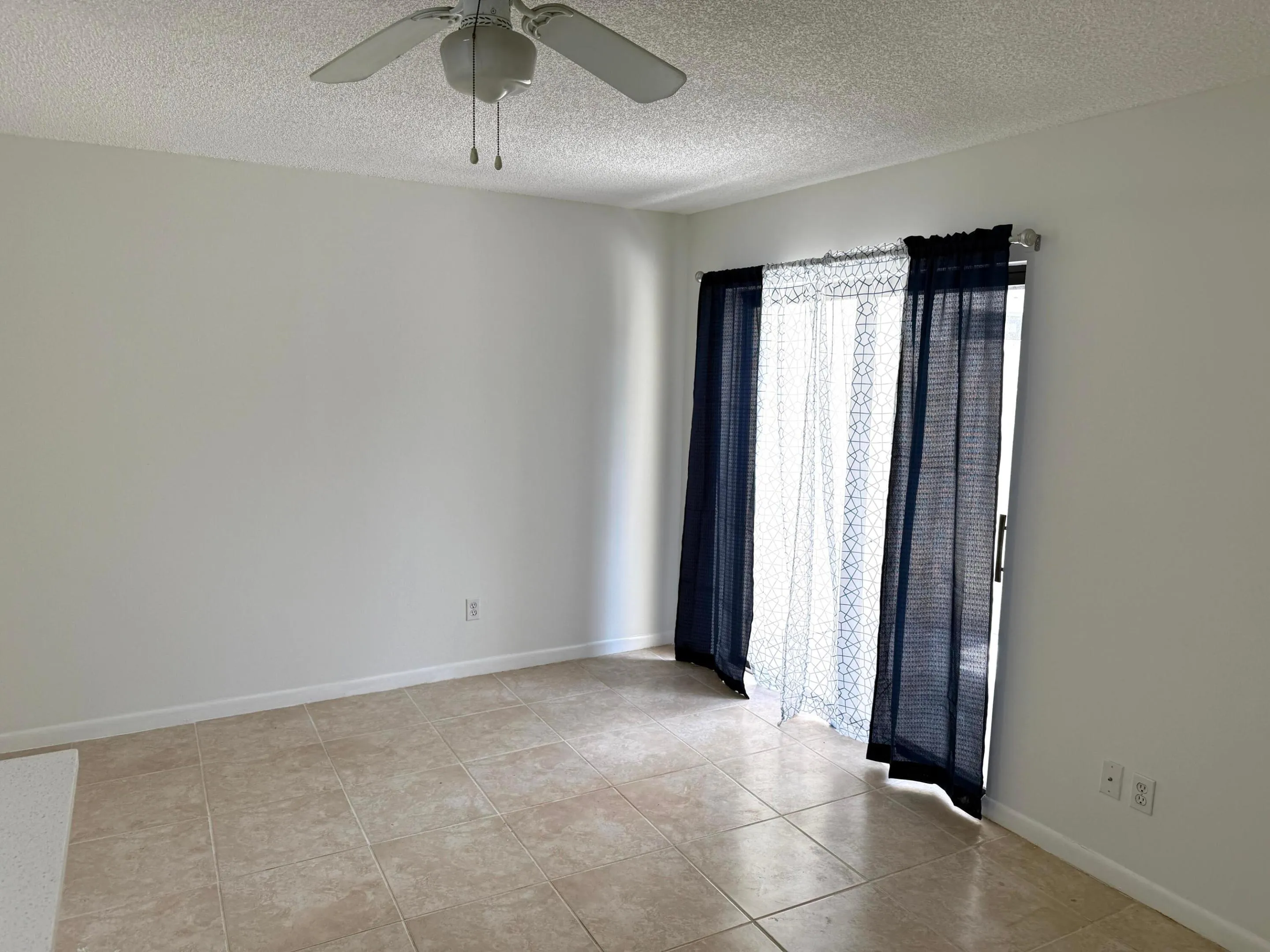 Recessed lighting, tile flooring, ceiling fan, and sliding glass door