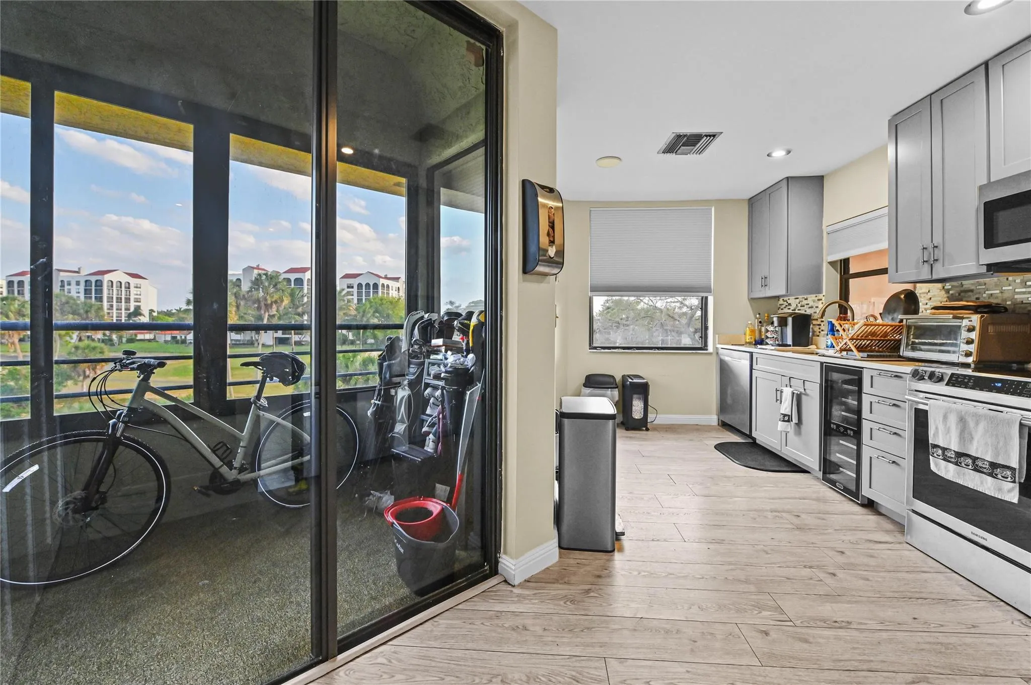 Kitchen has additional screened patio overlooking golf and lake view