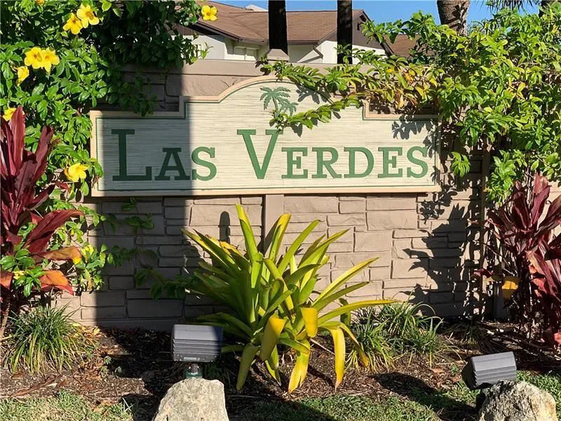 Community signage featuring a stone-look base with a decorative plaque